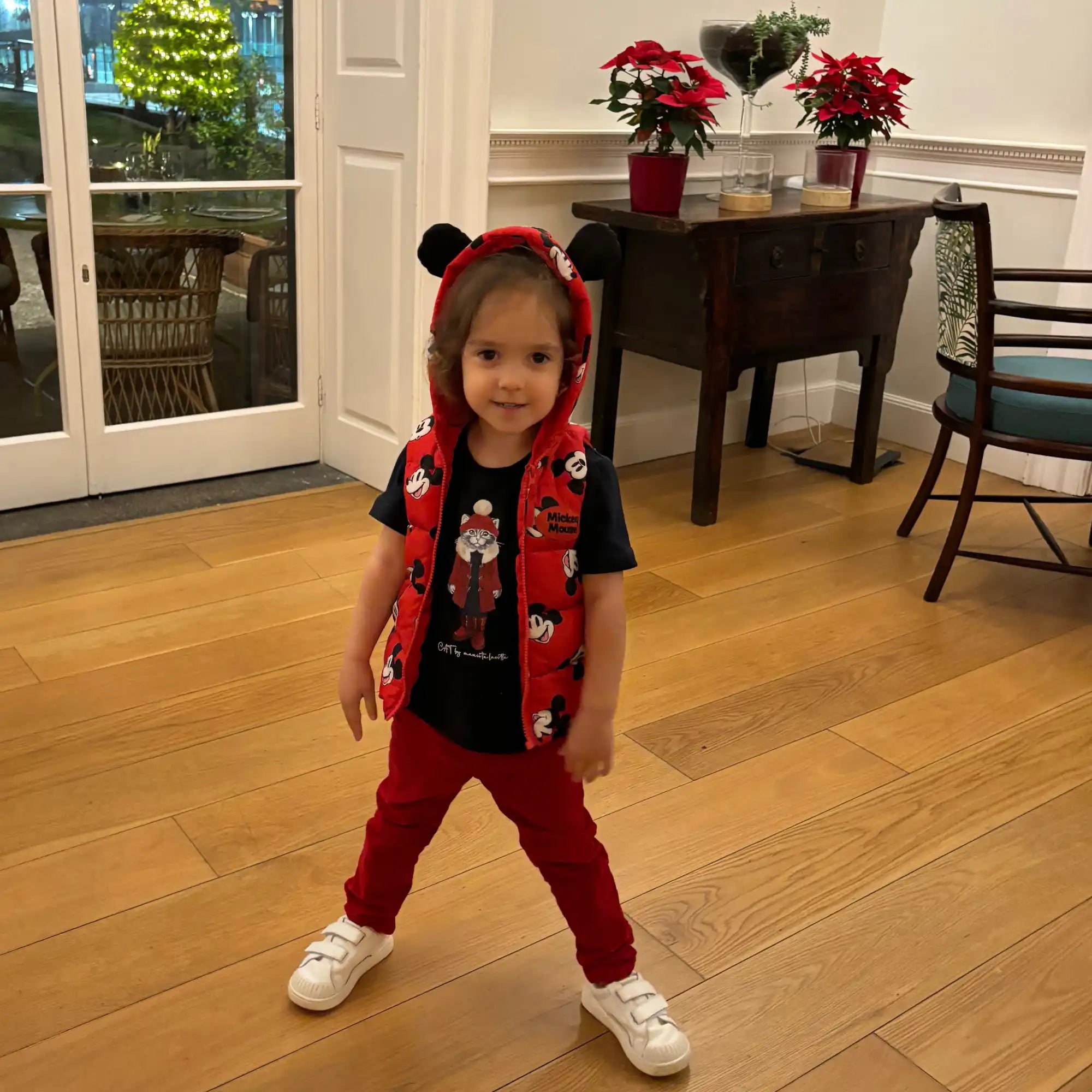 Child in Mickey Mouse vest.