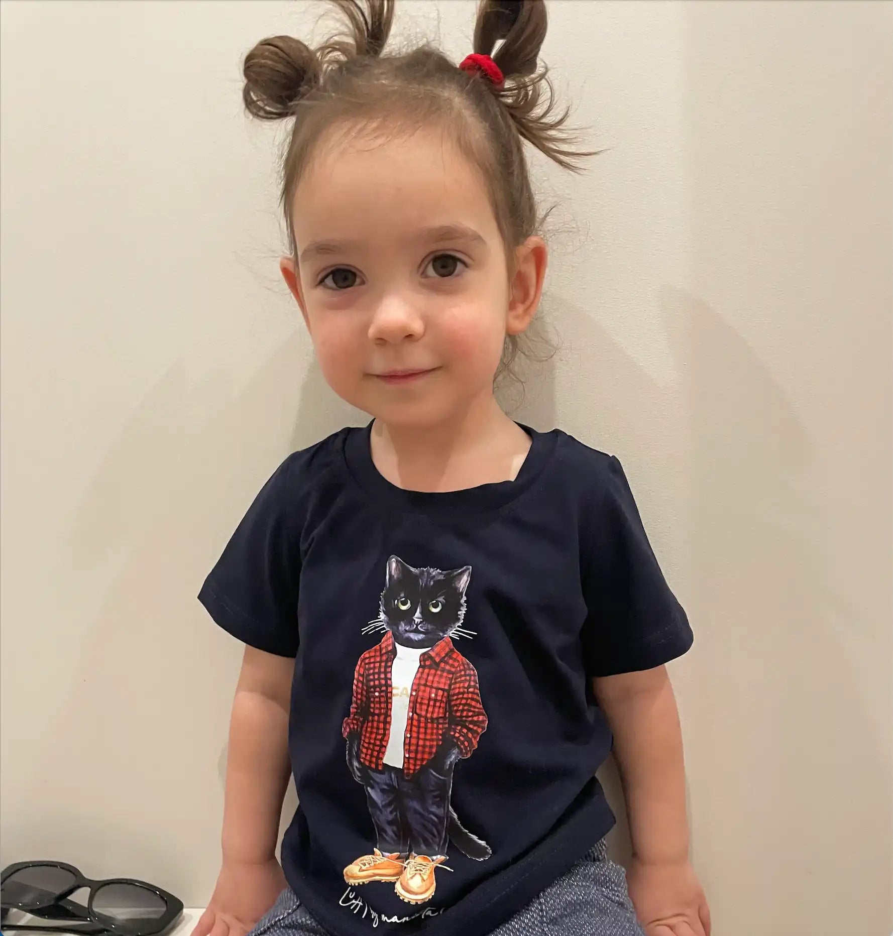 Child’s black t-shirt with cat graphic.