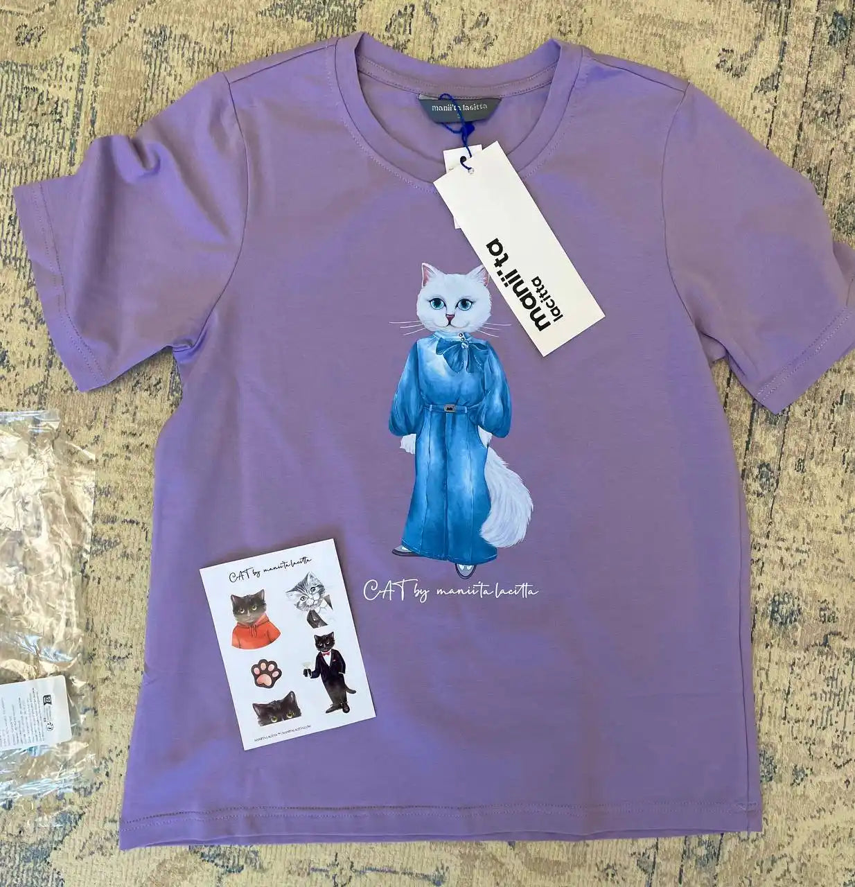 Lavender t-shirt with cat illustration.