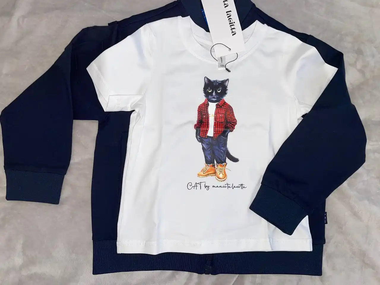 White t-shirt with cat graphic.